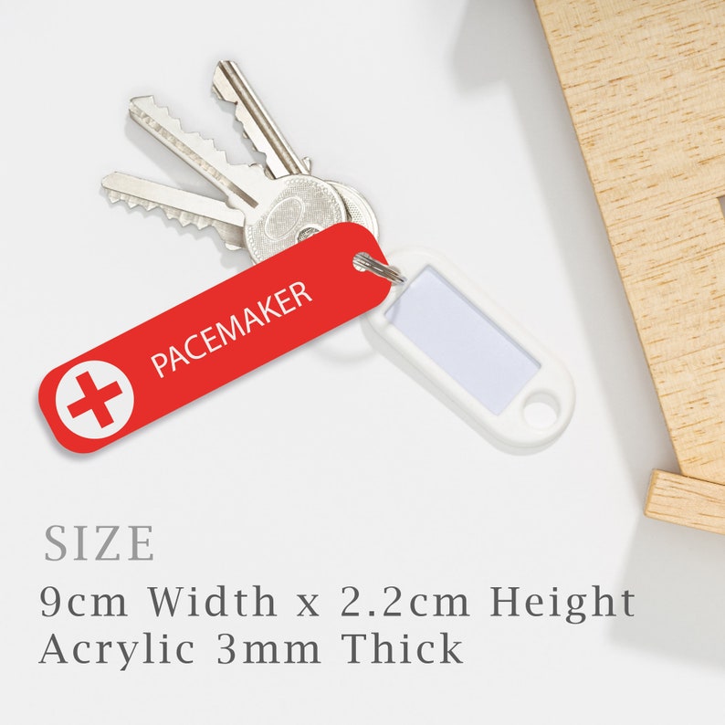 May include: Red acrylic keychain with a white plus sign and the text "PACEMAKER". The keychain is 9 cm wide, 2.2 cm high, and 3 mm thick.