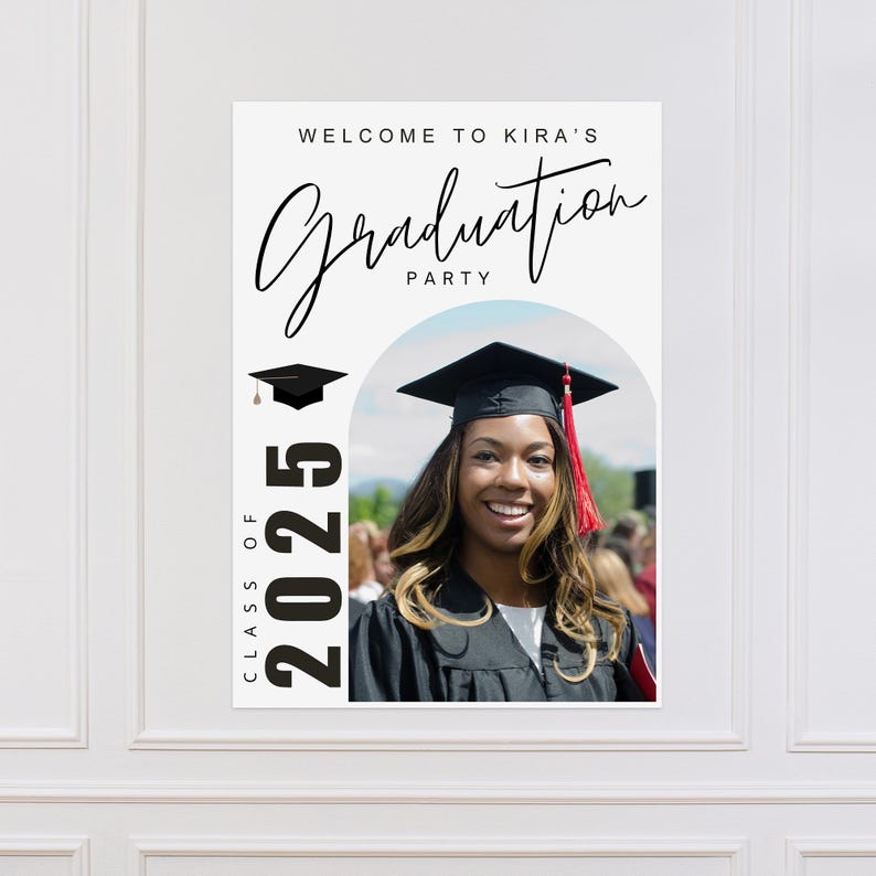 May include: A graduation party sign with the text "Welcome to Kira's Graduation Party" in elegant script. The sign features a photo of a smiling graduate wearing a cap and gown, with the year "2025" displayed prominently.