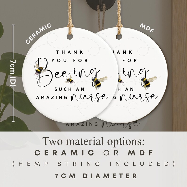 May include: Two white ceramic or MDF round ornaments with hemp string, each 7cm in diameter. The ornaments read "Thank you for Bee-ing such an amazing nurse" with bee illustrations.
