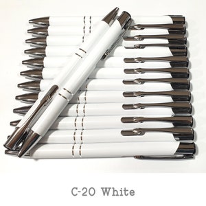 May include: A stack of white pens with silver accents and a silver clip. The pens are arranged in a row with the tips facing the viewer. The text "C-20 White" is printed below the pens.