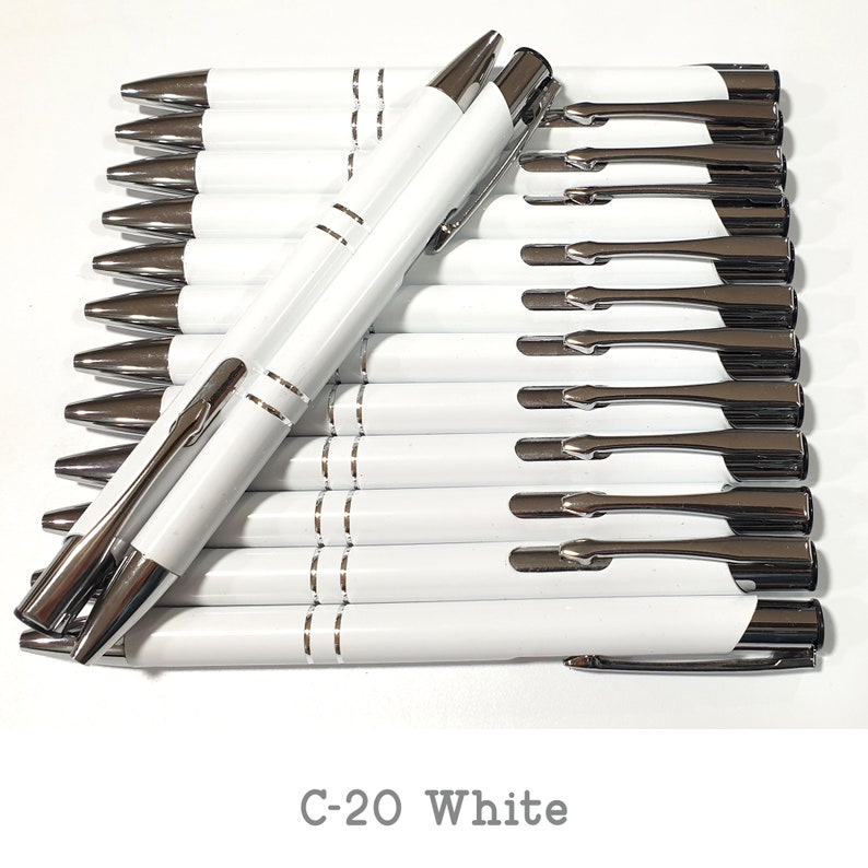 May include: A stack of white pens with silver accents and a silver clip. The pens are arranged in a row with the tips facing the viewer. The text "C-20 White" is printed below the pens.
