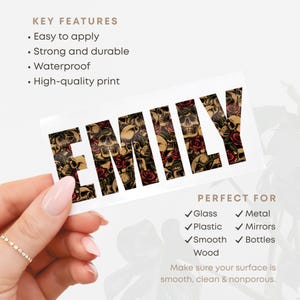 May include: A rectangular sticker with the name "EMILY" in a gothic font. The letters are filled with a pattern of skulls and red roses. The sticker is held by a hand with a gold ring. The text "KEY FEATURES" and "PERFECT FOR" are also visible.