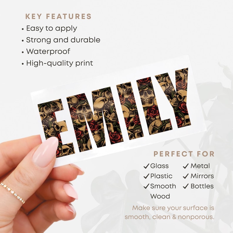May include: A rectangular sticker with the name "EMILY" in a gothic font. The letters are filled with a pattern of skulls and red roses. The sticker is held by a hand with a gold ring. The text "KEY FEATURES" and "PERFECT FOR" are also visible.