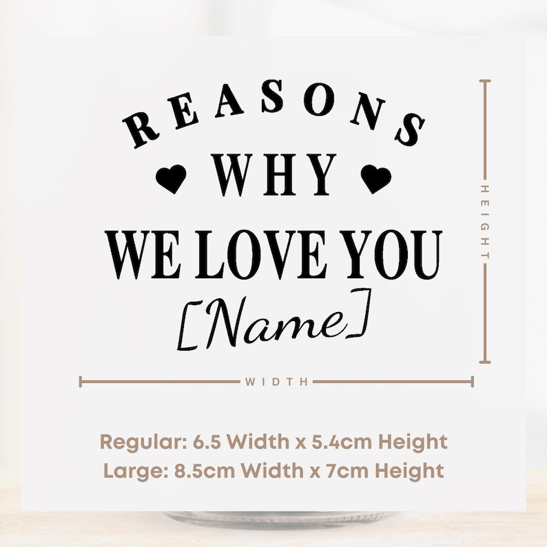 May include: A white card with black text that reads "REASONS WHY WE LOVE YOU [Name]". The card includes two black hearts. Measurements are provided: Regular 6.5" width x 5.4cm height, Large 8.5cm width x 7cm height.