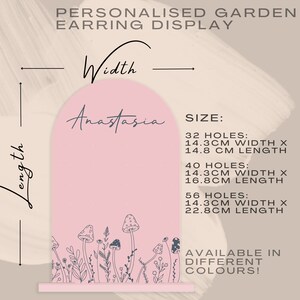 May include: Pink arch-shaped earring display with a mushroom and floral design. The display is available in three sizes: 32 holes (14.3 cm wide x 14.8 cm long), 40 holes (14.3 cm wide x 16.8 cm long), and 56 holes (14.3 cm wide x 22.8 cm long).