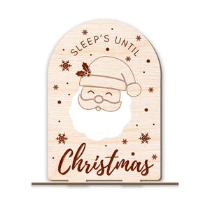 May include: Wooden Christmas countdown sign with a Santa Claus face cutout and the text "Sleep's Until Christmas".