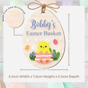 May include: Wooden Easter egg decoration, 7.5cm high, with the text "Bobby's Easter Basket". It features a chick hatching from an egg, flowers, and Easter eggs. Made from 3mm birchwood.