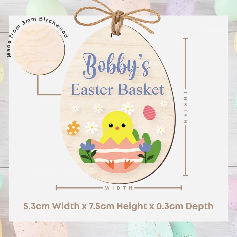 May include: Wooden Easter egg decoration, 7.5cm high, with the text "Bobby's Easter Basket". It features a chick hatching from an egg, flowers, and Easter eggs. Made from 3mm birchwood.