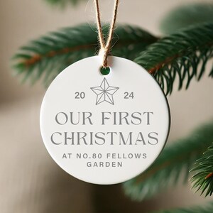 May include: White ceramic Christmas ornament with the text "Our First Christmas at No. 80 Fellows Garden" and a star design.