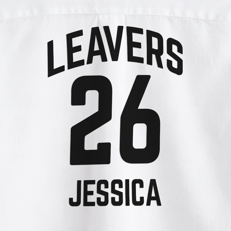 May include: White fabric with the black text "LEAVERS 26 JESSICA". The number 26 is centered below the word "LEAVERS". The name "JESSICA" is centered below the number 26.