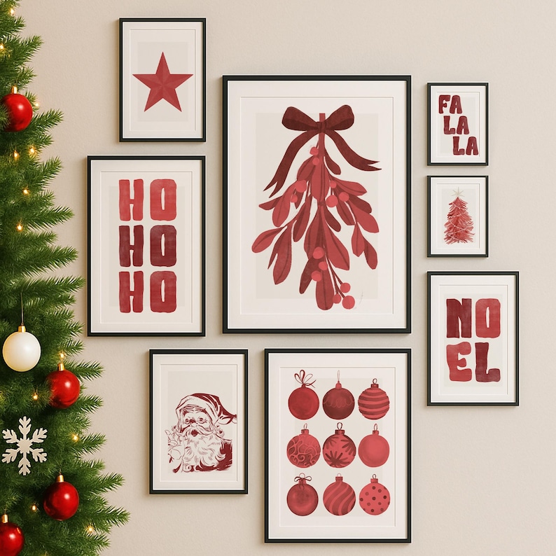 May include: A collection of framed Christmas-themed art prints. The prints feature festive imagery such as a red star, mistletoe, Christmas ornaments, and the words "HO HO HO", "FA LA LA", and "NOEL". The art is in red and white.