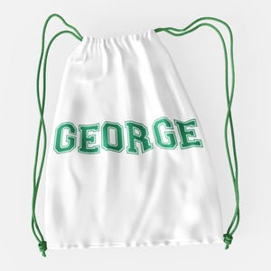 May include: White drawstring bag with green text that says "GEORGE" in a collegiate font.
