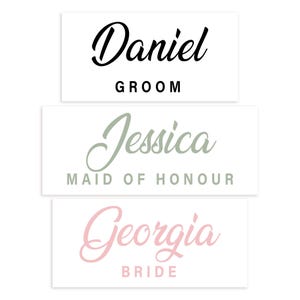 May include: Three rectangular white cards with names and titles in elegant script. The top card reads "Daniel" in black, with "GROOM" below. The middle card says "Jessica" in green, with "MAID OF HONOUR" below. The bottom card says "Georgia" in pink, with "BRIDE" below.