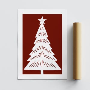 May include: A white Christmas tree illustration with a star on top, set against a deep red background. The tree has a simple, stylized design with horizontal lines. The artwork is on a white-bordered print, with a rolled-up poster tube beside it.