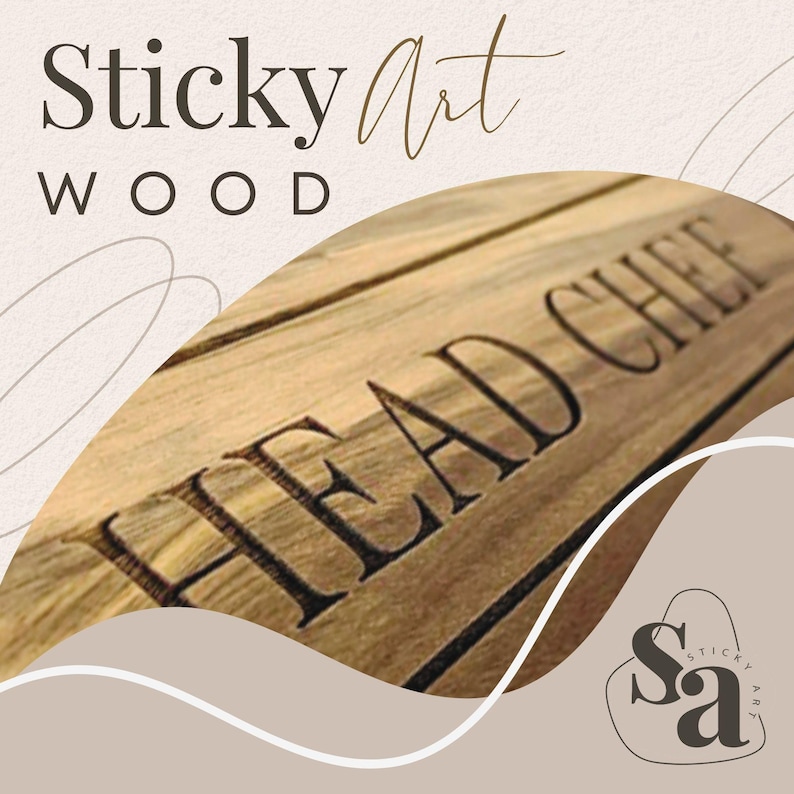 May include: A wooden cutting board with the text "Head Chef" engraved on it. The board is light brown with a natural wood grain. The text is in black and is centered on the board. The board is a product from Sticky Art Wood.