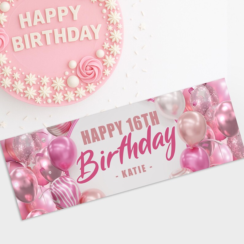 May include: A pink birthday cake with white floral decorations and the words "HAPPY BIRTHDAY". A banner reads "HAPPY 16TH Birthday - KATIE -" with pink balloons.