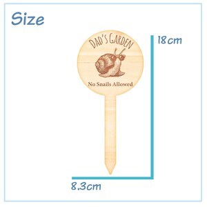 May include: A wooden garden stake with a round sign that says "Dad's Garden No Snails Allowed". The sign features a cartoon snail wearing sunglasses. The stake is 18 cm tall and 8.3 cm wide.