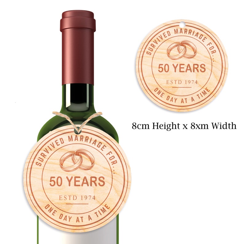 May include: Wooden round ornament with the text "Survived Marriage For 50 Years Estd 1974 One Day At A Time" and a graphic of two intertwined rings. The ornament is 8 cm in diameter.