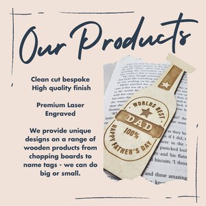 May include: A wooden bookmark shaped like a bottle with the text "Worlds Best Dad 100% Happy Father's Day" engraved on it. The bookmark is a light brown color and has a star on it.