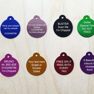 May include: Eight round dog tags with different colors and text. The tags are made of metal and have a hole for a ring. The text on the tags includes names, phone numbers, and messages like "I'm chipped" and "Special Diet Do Not Feed".