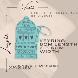 May include: A light blue slot machine-shaped keychain with the text "I hit the JACKPOT" and "WITH YOU" in the center. The keychain is 6 inches long and 3.6 inches wide.