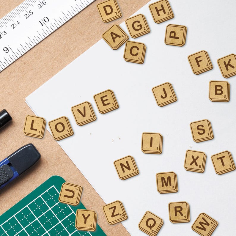May include: A set of wooden letter tiles spelling out the word "LOVE" with other letter tiles scattered around. The tiles are brown with white lettering.