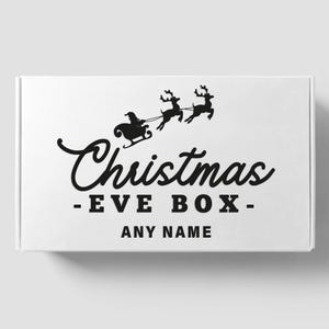 May include: White box with black text and a silhouette of Santa Claus in a sleigh pulled by reindeer. The text reads "Christmas - EVE BOX - ANY NAME".