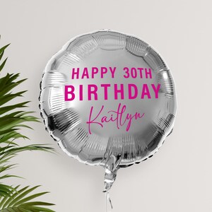May include: Silver balloon with the text "Happy 30th Birthday Kaitlyn" in pink lettering.