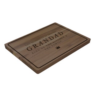 May include: A brown wooden cutting board with a black border and the text "This belongs to an amazing Grandad King of the Kitchen & the Family" with a crown symbol.