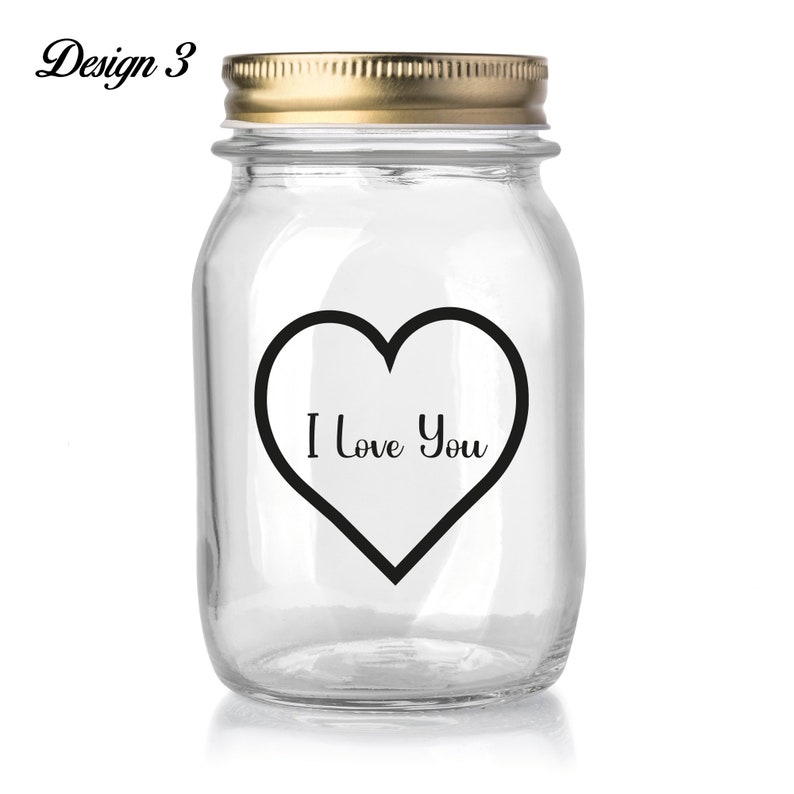 May include: A clear glass jar with a gold lid and a black heart sticker that says "I Love You".