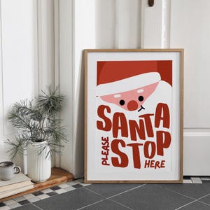 May include: A red and white Christmas sign with a cartoon Santa Claus face and the text "Please Santa Stop Here".