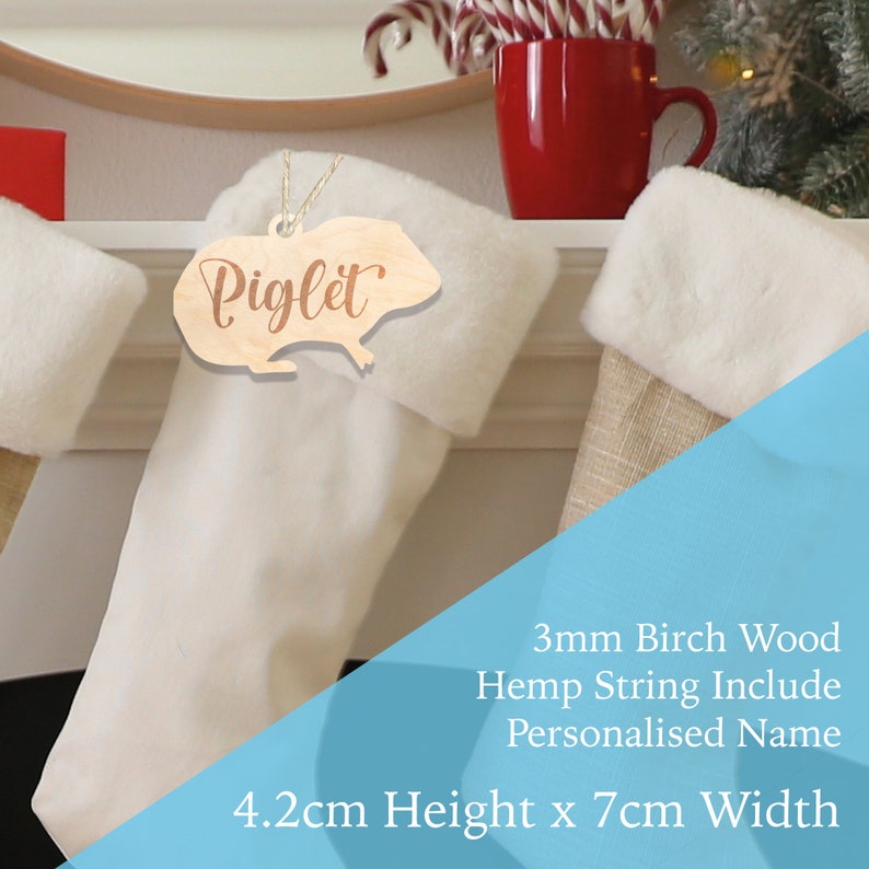 May include: Wooden Christmas stocking ornament shaped like a guinea pig with the name Piglet engraved on it. The ornament is 4.2 cm high and 7 cm wide and is made of 3 mm birch wood. It includes a hemp string for hanging.