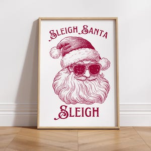 May include: A red and white illustration of Santa Claus wearing sunglasses with the text "Sleigh Santa Sleigh" on a white background.
