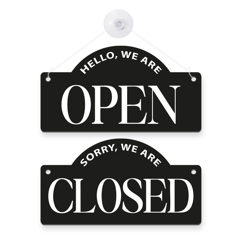 May include: Two black hanging signs with white text. The top sign reads "HELLO, WE ARE OPEN". The bottom sign reads "SORRY, WE ARE CLOSED". A white suction cup and string are attached to the top sign.