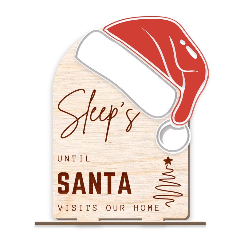 May include: A wooden sign with a red and white Santa hat on top. The sign says "Sleep's Until Santa Visits Our Home".