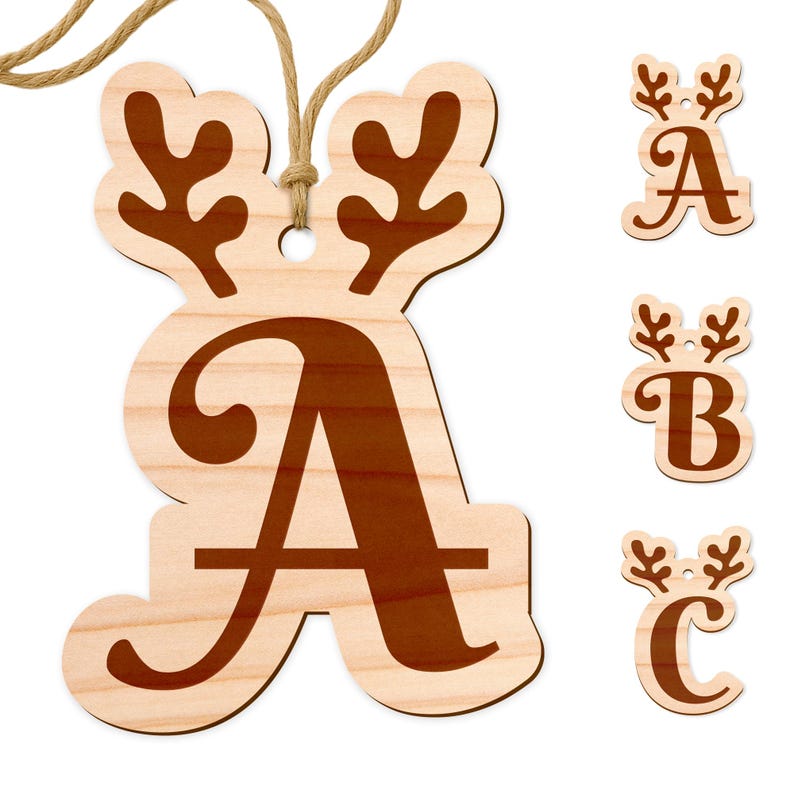 May include: Wooden Christmas ornaments in the shape of letters, with a reindeer antler design. The letter "A" is shown hanging with a twine string, and the letters "A", "B", and "C" are displayed separately. The ornaments are light brown with darker brown lettering.