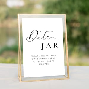 May include: A gold-framed sign with the text "Date Jar" and the instructions "Please share your date night ideas with the happy couple".