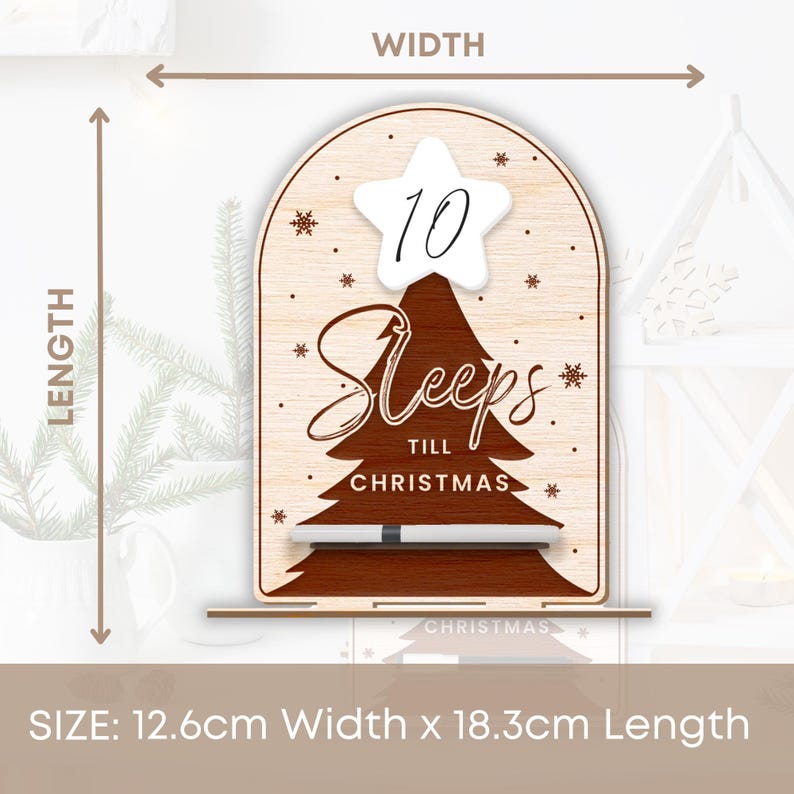Puede incluir: Un letrero de cuenta atr&aacute;s de Navidad de madera con una estrella blanca y el n&uacute;mero 10 en &eacute;l. El letrero dice "Sleeps Till Christmas" y mide 12,6 cm de ancho y 18,3 cm de largo.