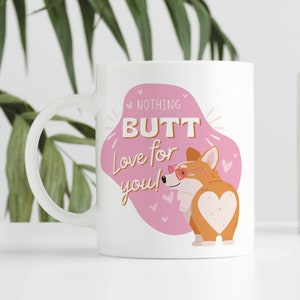 May include: White ceramic mug featuring a cartoon corgi with heart-shaped sunglasses and a heart-shaped butt. The mug has the text "NOTHING BUTT Love for you!" in a pink bubble with hearts.