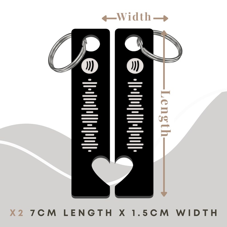 May include: Two black metal keychains with a heart-shaped cutout. Each keychain has a silver ring and a design of vertical lines and a music note symbol. The keychains measure 2.7 inches in length and 1.5 inches in width.
