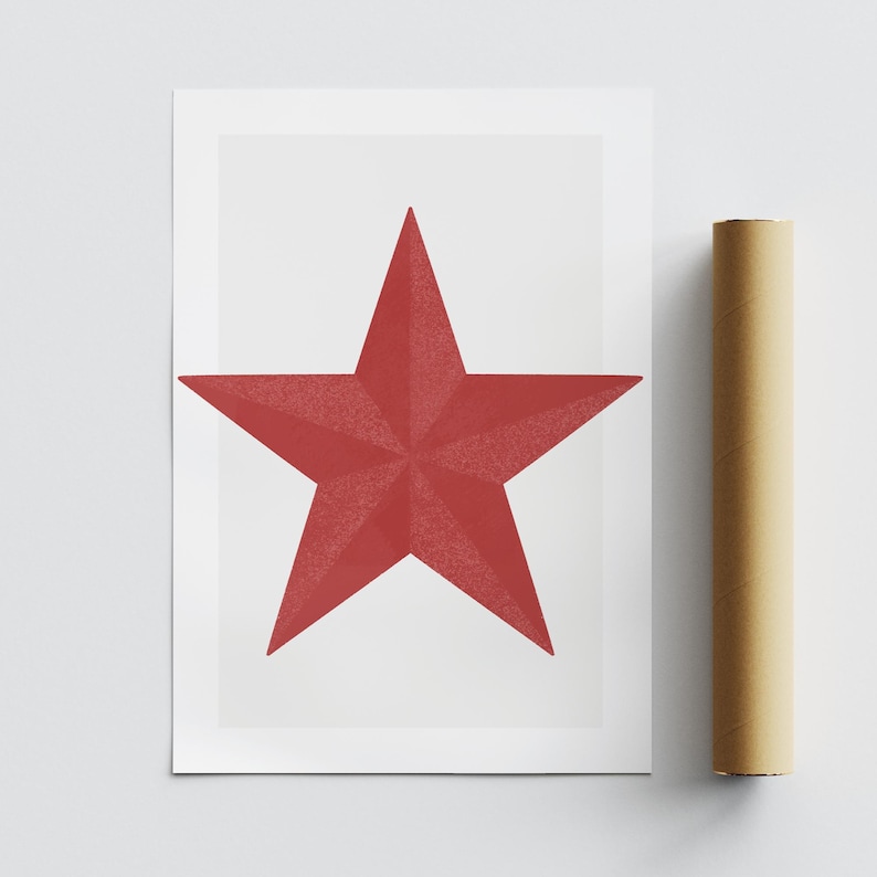 May include: A red star print on white paper. The star is a five-pointed shape with a textured surface. A rolled-up poster is next to the print.