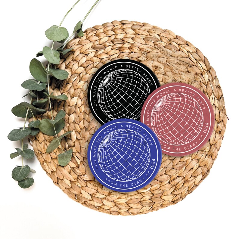 May include: Three round stickers with a globe design and the text "You make the world a better place from the class of 2024". The stickers are black, red, and blue.