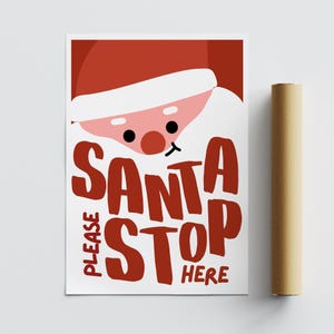 May include: A white background with a red and white illustration of Santa Claus's face. The text "PLEASE SANTA STOP HERE" is written in red.