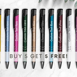 May include: Ten personalized pens in various colors, including blue, pink, green, gold, black, teal, burgundy, and silver. The pens have a black clip and a black cap. The text "Custom Text Here" is engraved on each pen. The text "BUY 5 GET 5 FREE!" is printed below the pens.