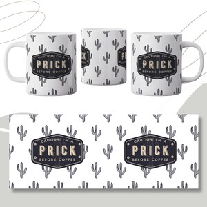 May include: White ceramic coffee mug with a black and white cactus design. The mug has the text "CAUTION! I'M A PRICK BEFORE COFFEE" printed on it.