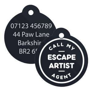 May include: Two black round pet ID tags. One tag has a phone number, address, and postcode. The other tag has the text "CALL MY ESCAPE ARTIST AGENT" in white.