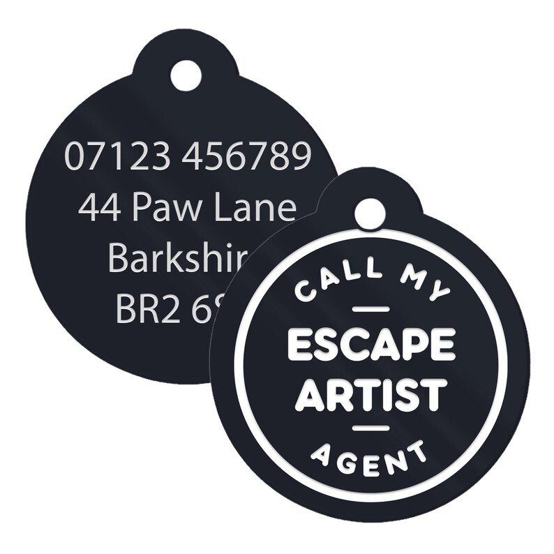 May include: Two black round pet ID tags. One tag has a phone number, address, and postcode. The other tag has the text "CALL MY ESCAPE ARTIST AGENT" in white.