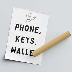 May include: A white poster with black text that reads "don't forget PHONE, KEYS, WALLE"