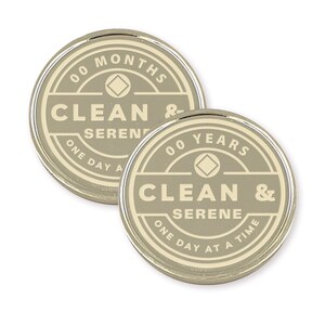 May include: Two silver-colored tokens with a beige background. The tokens feature a diamond symbol and the text "00 MONTHS CLEAN & SERENE ONE DAY AT A TIME" and "00 YEARS CLEAN & SERENE ONE DAY AT A TIME".