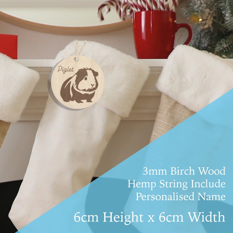 May include: A wooden Christmas ornament featuring a guinea pig silhouette with the name "Piglet" engraved on it. The ornament is 6 cm in height and 6 cm in width and comes with a hemp string for hanging.